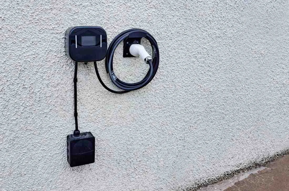 Electric car charger installation technician at work